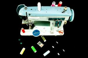 a sewing machine with various sewing supplies on it photo