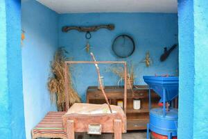 a blue room with a wooden table and a wooden chair photo