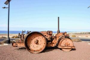 an old rusted tractor on the beach photo