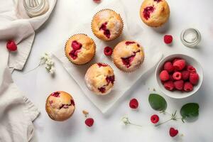 Raspberry muffins with fresh raspberries on a white table, close up, light background. Top view. A delicious dessert or breakfast. AI generated. photo