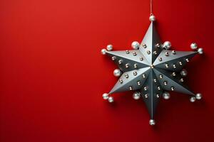 Christmas flat lay mockup with shining silver star decorated with pearls on red background with copy space. Top view of winter holiday decoration concept composition. photo