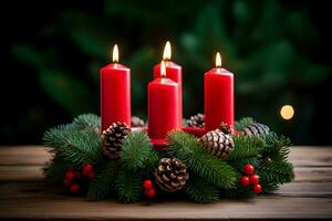 cuatro rojo ardiente velas para alemán adviento estación. Navidad guirnalda decoración en de madera antecedentes. foto