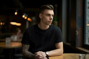 Young man wearing bella canvas black t shirt and jeans, at a cozy restaurant on summers day. Design tshirt template, print presentation mockup. Ai generated. photo