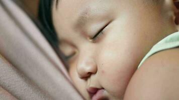 Baby sleeping in his mother's arms. Boy Sleeping On His Mother. Close Up video