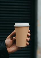 cropped view of man holding paper cup of coffee in hand on black background Generative AI photo