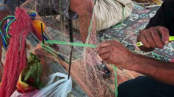 Fisherman Repairs Fishnets Fishing Lines video