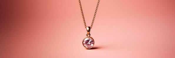 A delicate minimalist golden pendant necklace isolated on a pink gradient background photo