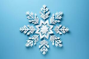 Beautiful DIY paper snowflakes in mid creation isolated on a blue gradient background photo