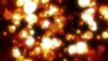 Abstract yellow blurred holiday background with magical bokeh of glowing bright light energy small particles of flying dots on a black background video