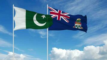 Pakistan en kaaiman eilanden vlaggen golvend samen in de lucht, naadloos lus in wind, 3d renderen video