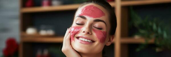 A female artist rejuvenating her skin with a refreshing pomegranate facial mask while in her art studio relaxing spa background with empty space for text photo
