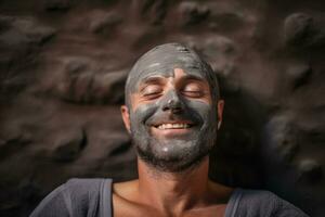 A bald man with beard enjoying a mud facial mask in a tranquil spa setting relaxing spa background with empty space for text photo