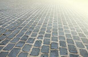 Surface is paved with road tiles of different sizes as texture photo