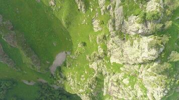 Rocky cliff and green hills. Aerial view. Vertical shot. video