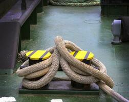 docked boat tied with nautical rope and knot photo