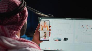 Islamic teleworker and coworkers in internet video call checking analytics statistical data sets. Arab employee optimizing key performance indicators in teleconference meeting, close up