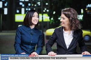 Journalists present global cooling trend as innovation to adjust temperature and weather forecast, live tv transmission. Presenters team doing reportage on new technology trend. photo