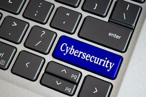 Cybersecurity text on blue keyboard. Secure access for online privacy and personal data protection photo