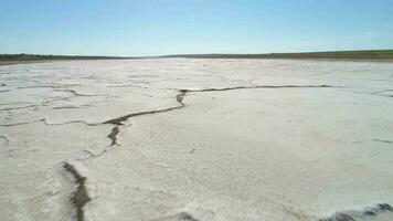 Salt Lake with deposits of white salt and cracks. Aerial view. video