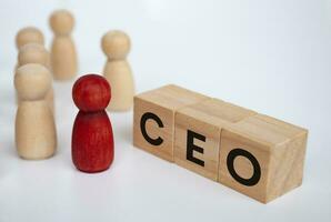 CEO text on wooden blocks with wooden figure representing leader. Leadership concept photo