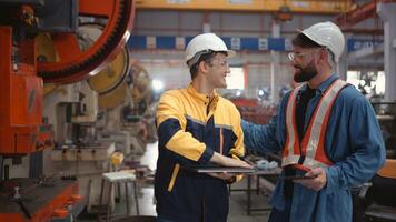 Engineer and technician discussing machinery in factory to plan inspection maintenance according to usage cycle, Concepts inspections based on usage cycle maintenance photo