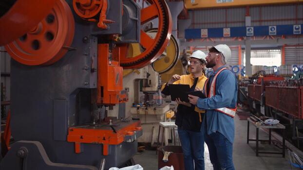 Engineer and technician discussing machinery in factory to plan inspection maintenance according to usage cycle, Concepts inspections based on usage cycle maintenance photo
