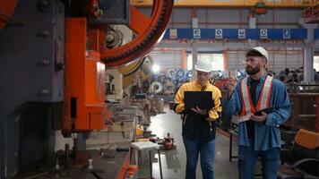 Engineer and technician discussing machinery in factory to plan inspection maintenance according to usage cycle, Concepts inspections based on usage cycle maintenance photo