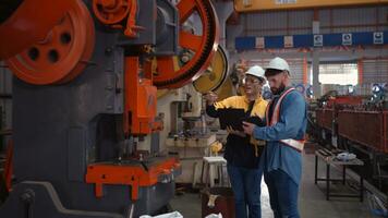 Engineer and technician discussing machinery in factory to plan inspection maintenance according to usage cycle, Concepts inspections based on usage cycle maintenance photo