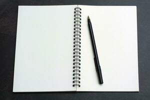 Directly above view of office desk table with pen and notepad. Copy space. photo