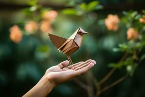 Hand folding origami bird in a peaceful setting background with empty space for text photo