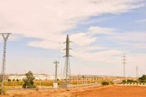 a field with electricity poles and wires photo