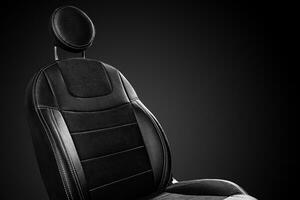 Comfortable front car seat back with round headrest on black background photo