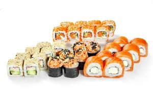 Set of classic Philadelphia, California crab, uramaki in tobiko, hosomaki with salmon photo