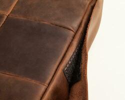 Closeup of brown leather seat cushion with hook-and-loop fastener photo