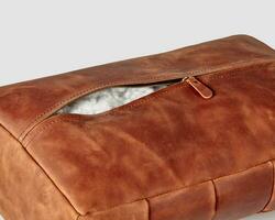Hand-stitched copper-colored leather footrest with zipper and holofiber filling photo