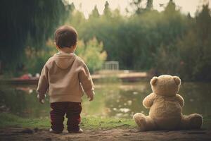 Cute little boy with teddy bear in the park at sunset, rear view of babysitting Toddler beside his teddy bear, AI Generated photo