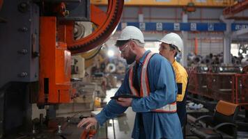 Engineer and technician discussing machinery in factory to plan inspection maintenance according to usage cycle, Concepts inspections based on usage cycle maintenance photo