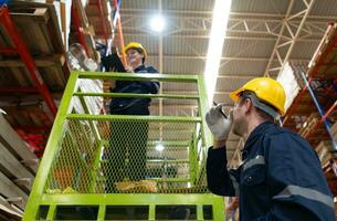 Warehouse workers using forklift to check and counting in a large warehouse. This is a large paper package storage and distribution warehouse. photo