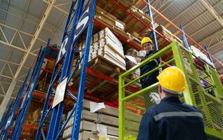 Warehouse workers using forklift to check and counting in a large warehouse. This is a large paper package storage and distribution warehouse. photo