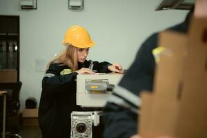 Warehouse workers in uniform and hardhats working in a paper factory photo