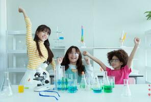 In the science classroom, an Asian child scientist experimenting with scientific formulas with chemicals photo