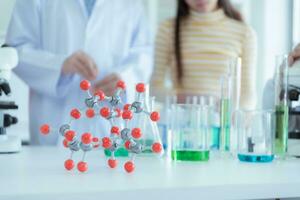 In the science classroom, an Asian child scientist experimenting with scientific formulas with chemicals photo