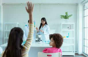 In the science classroom, an Asian child scientist experimenting with scientific formulas with chemicals photo