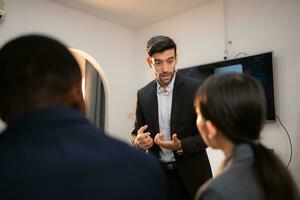 Multiethnic group of business people working together in a modern office photo