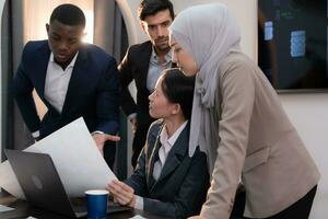 Multiethnic group of business people working together in a modern office photo