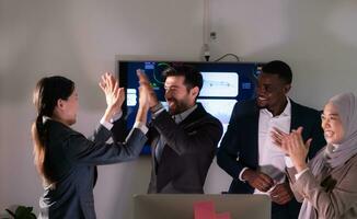 Group of business people discussing the charts and graphs showing the results of their successful teamwork, Emotions of business people who work successfully photo