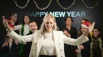 New Year party, Group of young people in Santa hats blowing confetti while celebrating new year photo