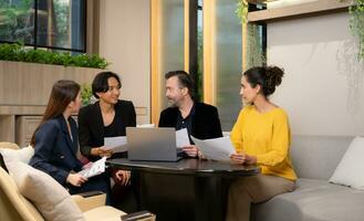 Group of business people discussing business plan at meeting table in office. photo