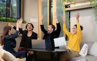 Group of happy business people celebrating success in office. Business success concept. photo