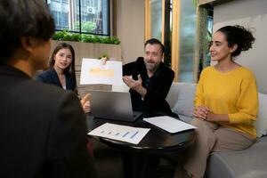 Businessman and businesswoman discussing a project in the meeting room of co-working space photo